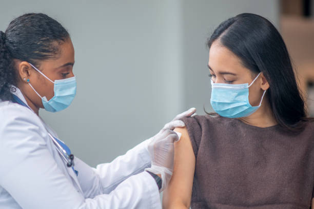 istock Preparing a Patients Arm for a Vaccination 1348102184