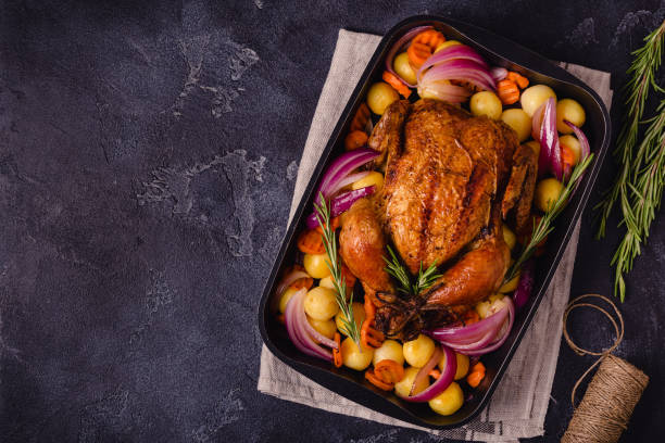 istock Whole baked chicken with vegetables 1348103007