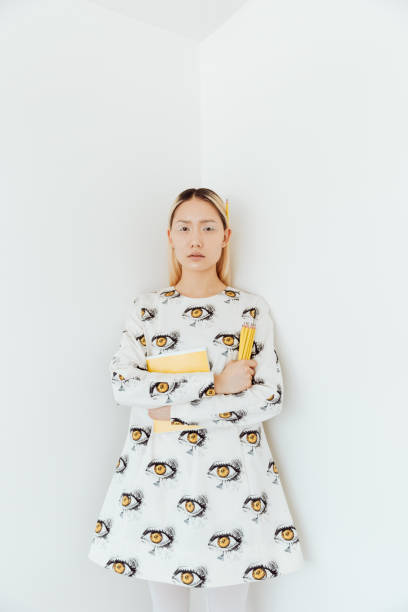 istock Amazing lady standing over wall with pencils and notebooks 1348103448