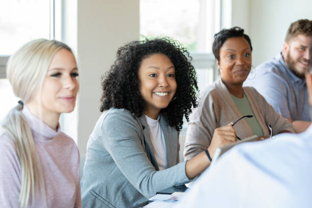 istock Successful group of diverse women attending workshop or professional development meeting 1348104183