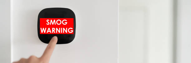 istock Smog warning on smart home air quality touchscreen indoor AQI screen alert. Panoramic banner of woman touching domotic device 1348104456
