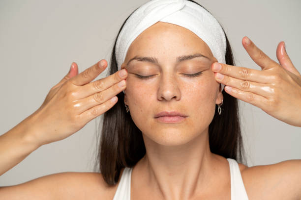 istock a young woman massaging her face 1348104919