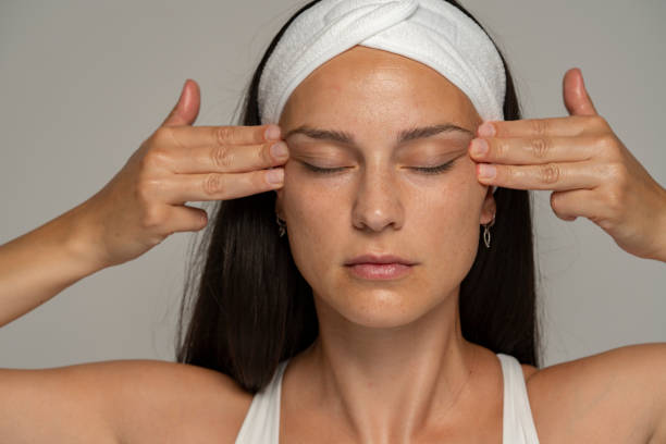 istock a young woman massaging her face 1348105450