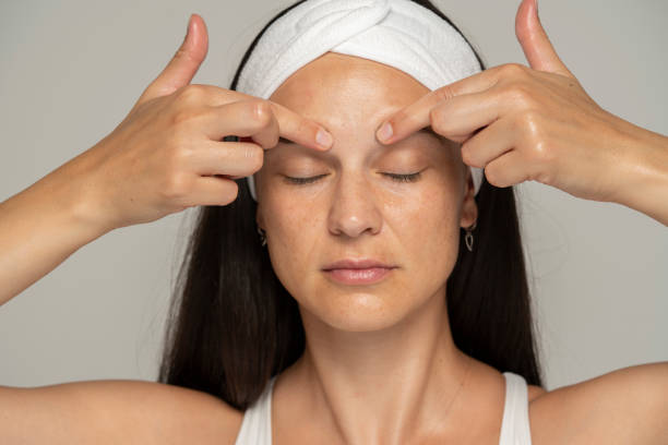istock a young woman massaging her forehead 1348105462