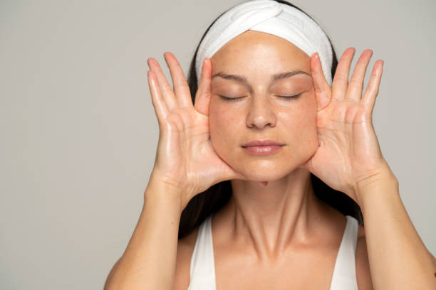 istock a young woman massaging her face 1348105466
