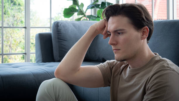 istock handsome young man Anxious, worried, and bored expression. A young man sits and works in a work-from-home manner, but becomes bored and worried, possibly due to depression. 1348107268