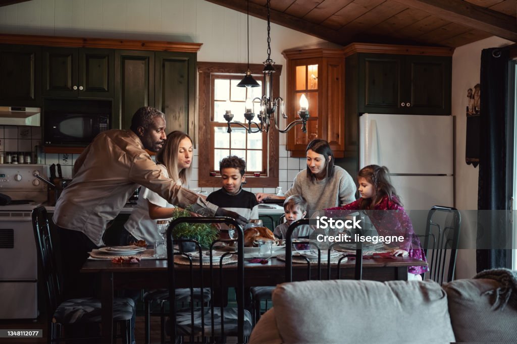 Friends celebrating Thanksgiving Friends, in a house, celebrating thanksgiving and Xmas Family Stock Photo