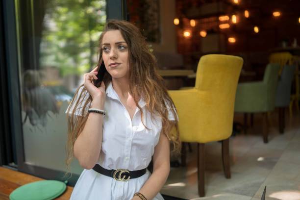istock Businesswoman using laptop while enjoying work at cafe table with cup of coffee 1348114547