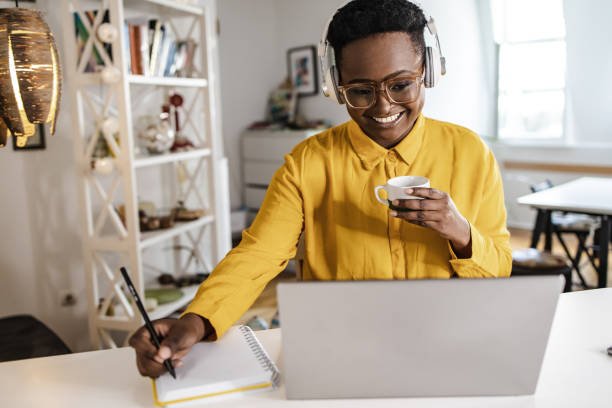 istock Young woman at home, working on the laptop 1348114733