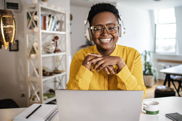 istock Young woman at home, working on the laptop 1348115455
