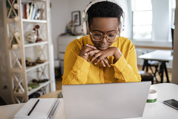 istock Young woman at home, working on the laptop 1348115497