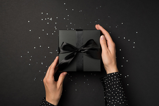 High angle view of Christmas present wrapped in black paper