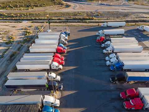 Semi Trucks Parked Side By Side, At A Truck Stop, For A Break Half Way Through The Eleven Hour Limited Drive Time For Rest