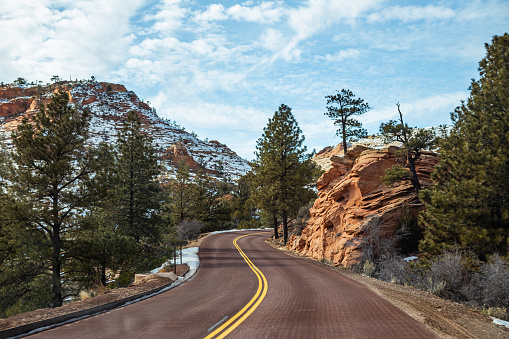 Red winding roads and snowy mountain of Zion National Park in Utah, USA