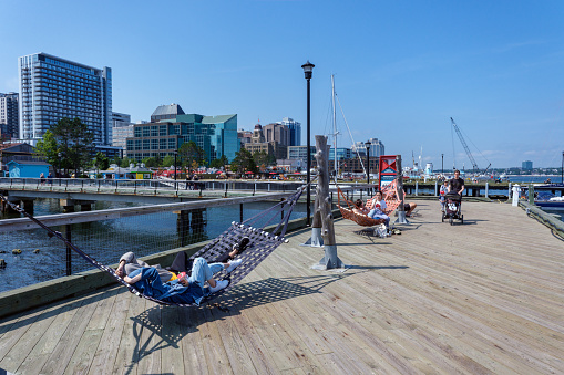 Halifax, Nova Scotia, Canada - 10 August 2021: People enjoy sunny day at Halifax Harbourfront, Canada