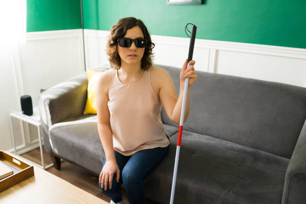 istock Visually impaired woman using a cane to walk 1348122743