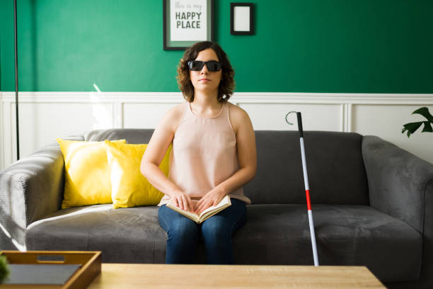 istock Beautiful woman with a disability learning to read 1348124746