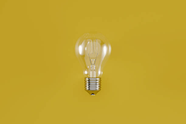 istock Off classic light bulb with filament on yellow background 1348126965