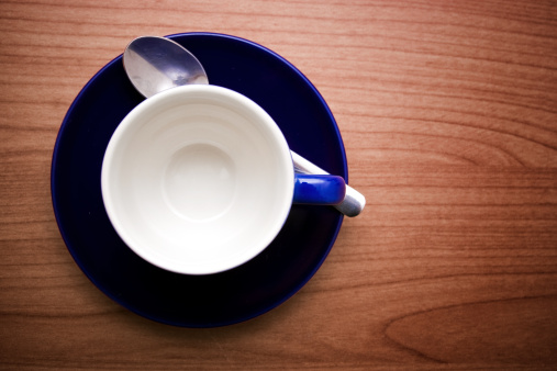 Empty coffee cup. Wooden table background. Copy space.