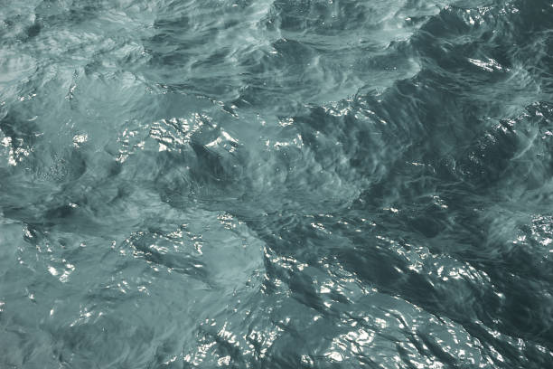 istock Texture blue sea water with sunny reflections 1348127656