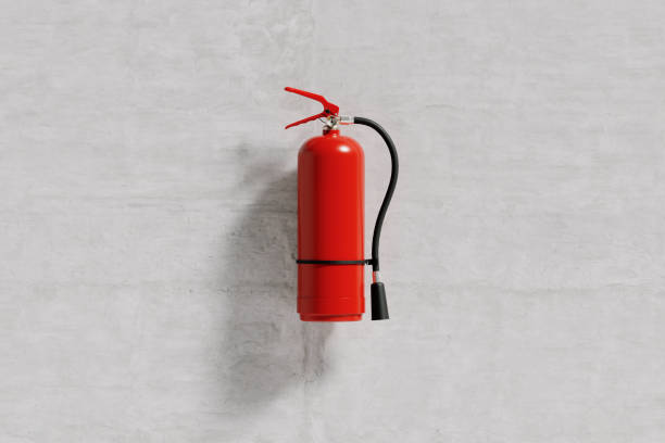 istock Red fire extinguisher isolated on a concrete wall of a building 1348127801