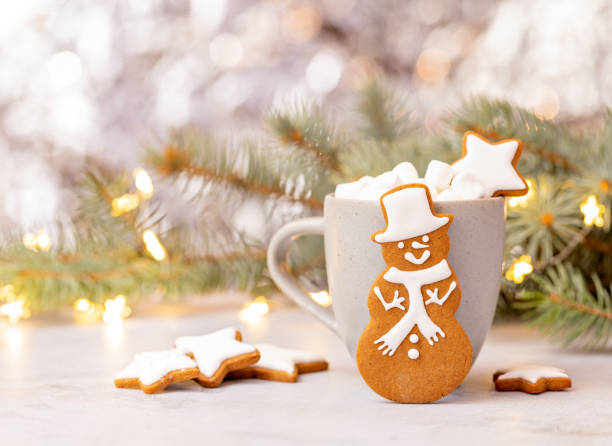 istock Cute Gingerbread Snowman Cookie in front of Hot cocoa with Marshmallows. 1348129787