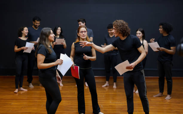 Acting students doing an improv exercise in a drama class Latin American acting students doing an improv exercise in a drama class with the guidance of their coach rehearsal photos stock pictures, royalty-free photos & images