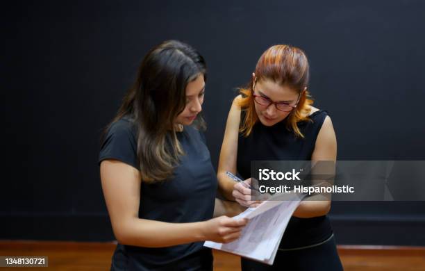 Drama Teacher Helping A Student With Her Script In An Acting Class Stock Photo - Download Image Now