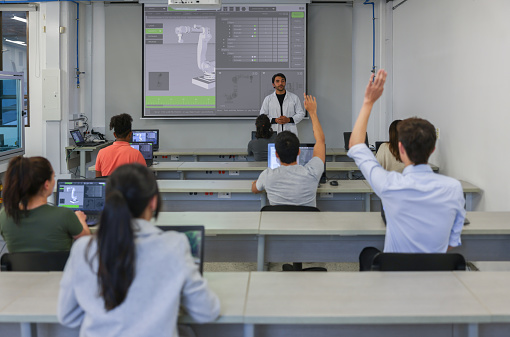 Group of Latin American students in a robotics class at the university asking questions to the teacher - education concepts