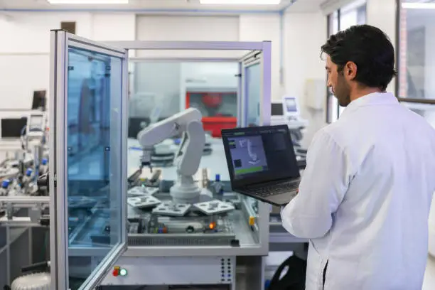 Photo of Teacher in a STEM class at the lab developing a robotic arm