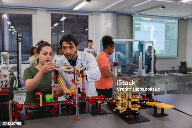 Teacher Helping A Female Student In A Robotics Class At The University Stock Photo - Download Image Now
