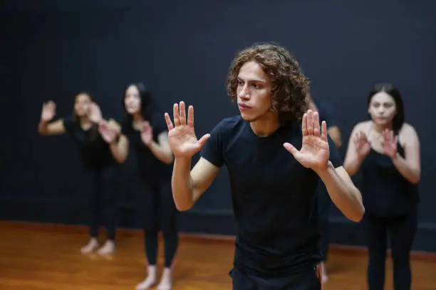 Group of Latin American theatre acting students doing pantomime in an improv class