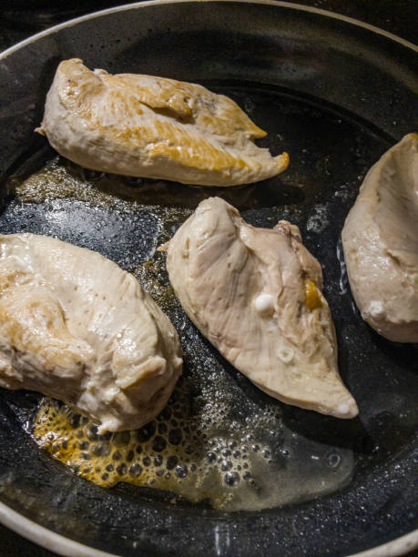 istock Chicken breast fillets on frying in a pan. 1348134461