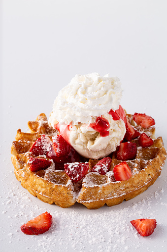 Strawberry waffle with ice cream and whipped cream