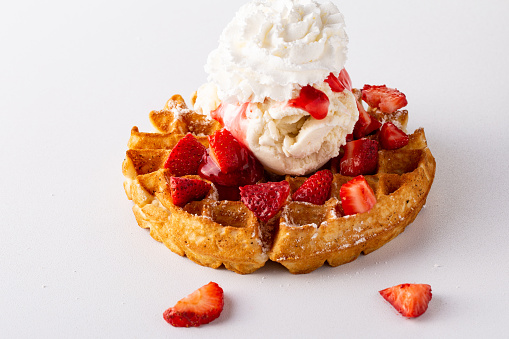 Strawberry waffle with ice cream and whipped cream