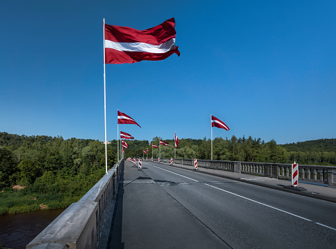 Bridge over Gauja River with Latvian Flags - Sigulda, Latvia