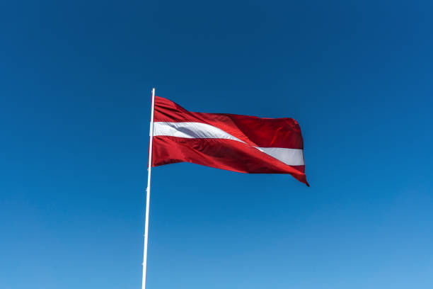 istock Latvian National Flag with a blue sky - Latvia 1348143174
