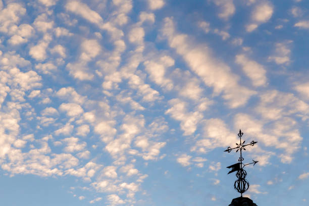 Weather vane and sky with lots of clouds. Meteorology. Cardinal points