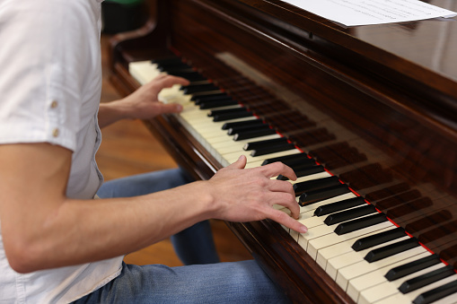 Close-up on a man playing the piano - music concepts