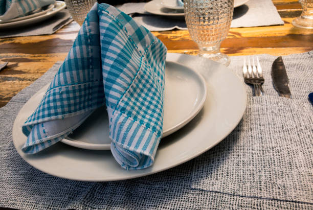 istock Table set in restaurant. Dishes, cutlery, glass & cloth on a restaurant table. 1348152368