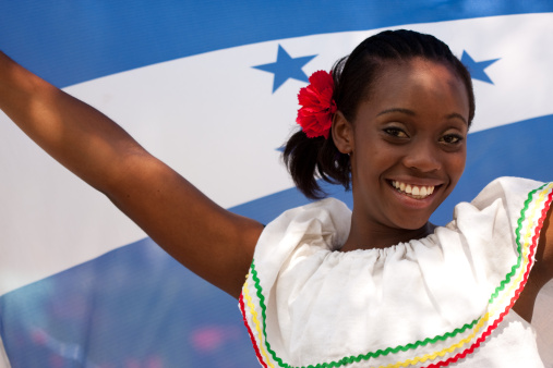 Honduran Welcome Beauty with the National Flag on background.