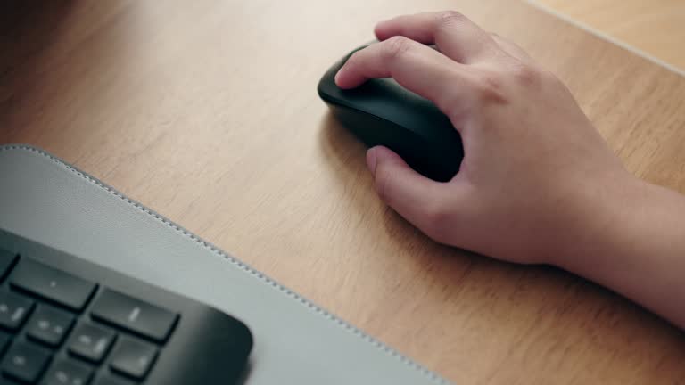 Close up of human hand using mouse for working on computer