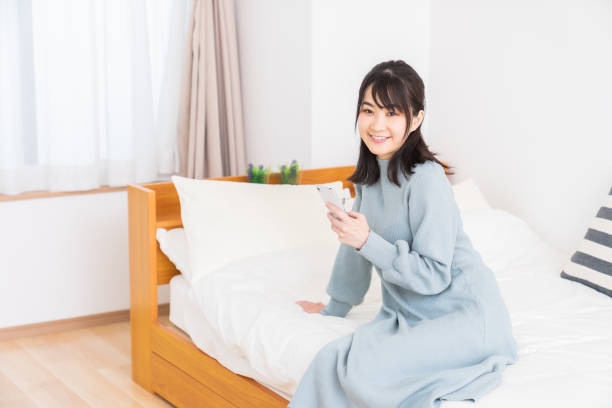 istock attractive Asian woman using a smart phone 1348153858
