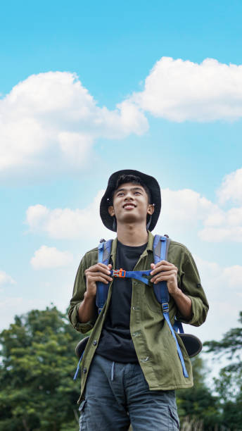 istock young Asian man traveler with backpack in reservoir 1348155628