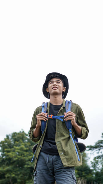 istock young Asian man traveler with backpack in reservoir 1348155629