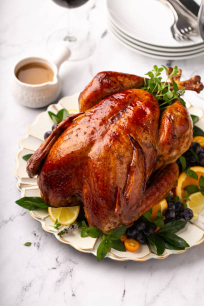 Thanksgiving or Christmas turkey Thanksgiving or Christmas roasted turkey served with gravy sauces table turkey christmas stock pictures, royalty-free photos & images