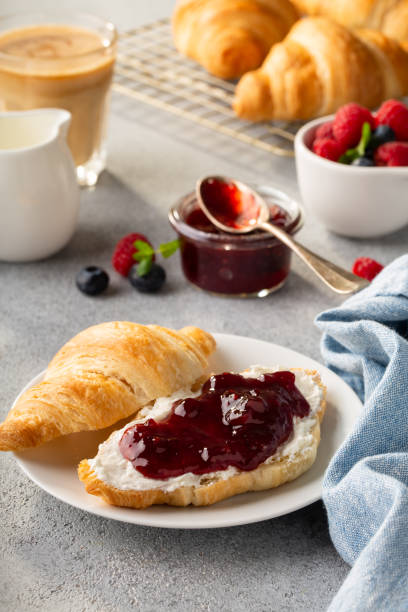 istock Fresh summer breakfast with croissants and berry jam 1348158847