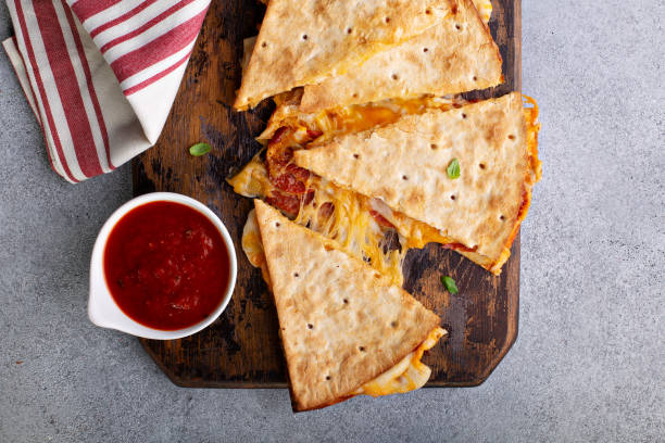 Pizza quesadilla with marinara sauce Pizza quesadilla with pepperoni and marinara sauce with cheese pull tortilla flatbread stock pictures, royalty-free photos & images