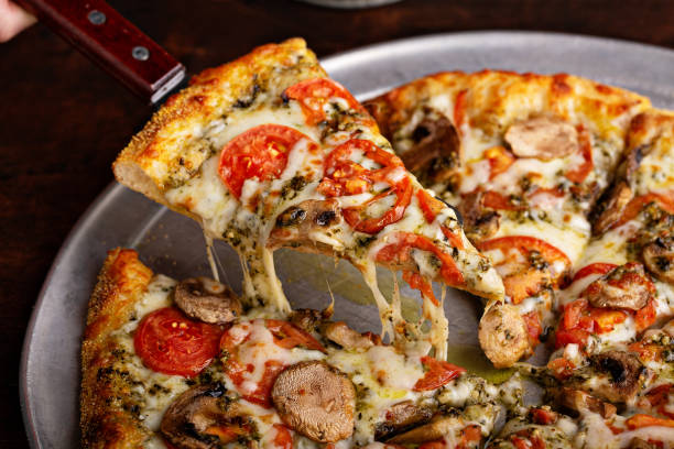 istock Vegetarian pizza with mushrooms and pesto sauce 1348158983
