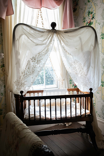 Antique crib in the Nursery at Rosedown Plantation, built in 1834 by Daniel Turnbull one of America's wealthiest families, St. Francisville, Louisiana, USA